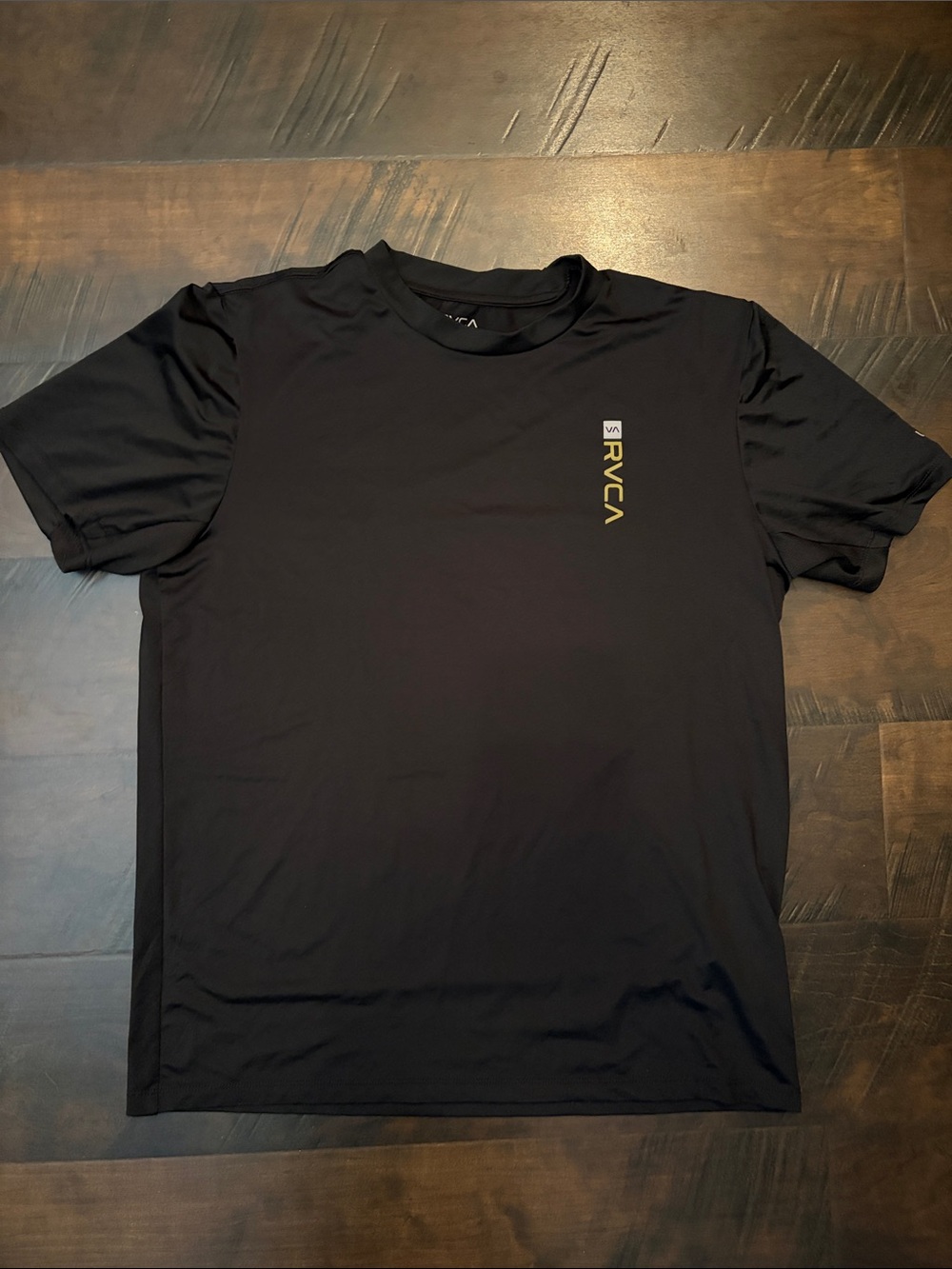 RVCA Black Short sleeve Tee dry fit with Vertical Yellow-Gold Logo